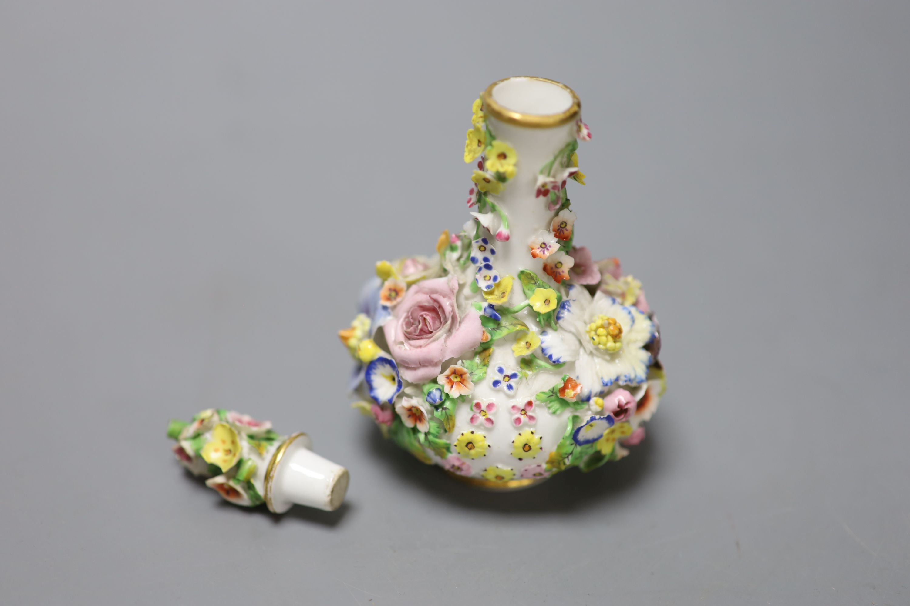 A rare mid 19th century Derby flower encrusted scent bottle, crown D mark in red, height 13cm